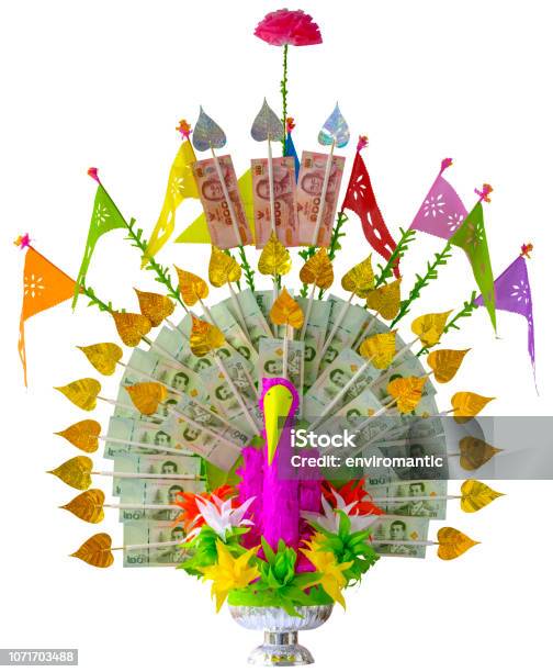 Colorful Craft Made Elaborate Thai Traditional Krathin Buddhist Ceremony Money Tree Offering Complete With Thai Bank Notes In The Shape Of A Peacock Isolated On White Clipping Path Included Stock Photo - Download Image Now