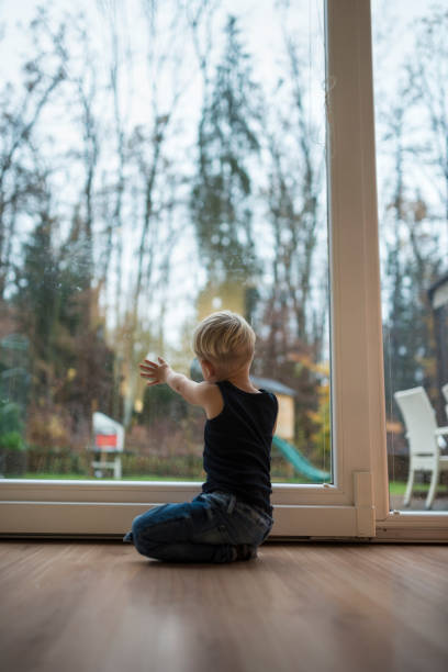 istock Little boy kneeling on a wooden floor 1071705646