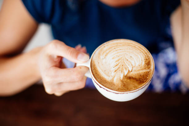 istock Cup of cappuccino in hands. 1071706360