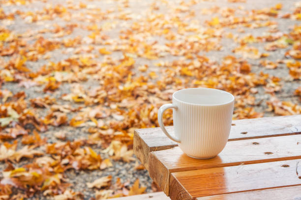 istock Autumn Fall Background with maple leaves and white cup - Autumn Card for your design, top view with copy space 1071710258