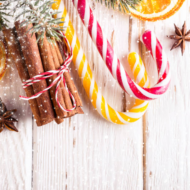 istock Christmas white background with Candy canes and cinnamon sticks close-up 1071712704
