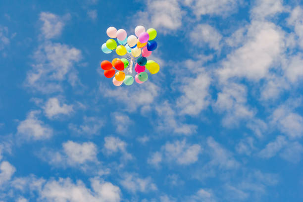 istock flying colorful toy balloon on a blue sky 1071719208