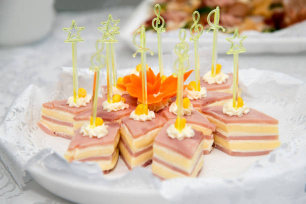 istock Close up of small canapes arranged on a plate over light background - selective focus 1071719594