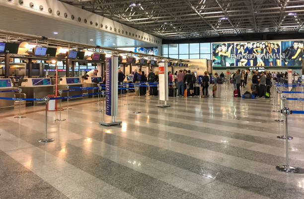 passengers lined up for chek-in inside the milan-malpensa airport terminal 1. - travel passenger milan italy italy imagens e fotografias de stock