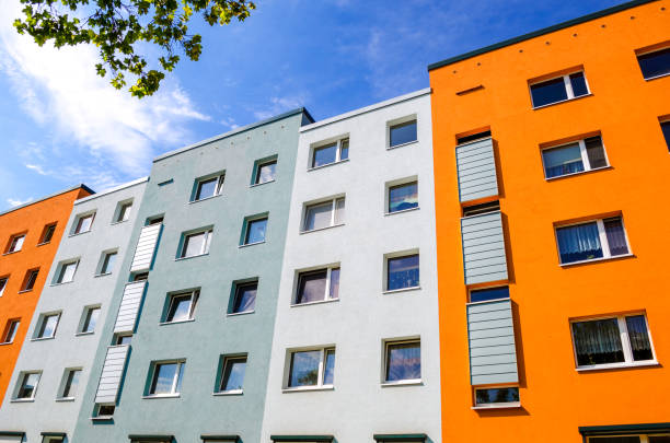 Colorful house facades with windows of apartment buildings stock photo