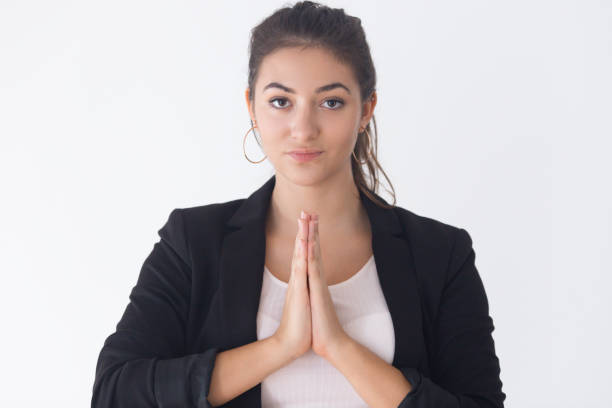 istock Serious pretty Caucasian girl pressing hands in mudra gesture 1071729564
