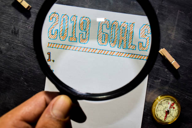 istock 2019 Goals handwritten text on the paper with marker, compass and use magnifying glass 1071731564