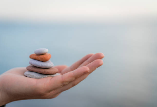 istock Pile of stacked stones in human hand 1071736036