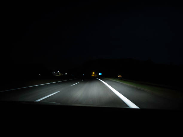 istock moving road at night shot through the windshield 1071737994