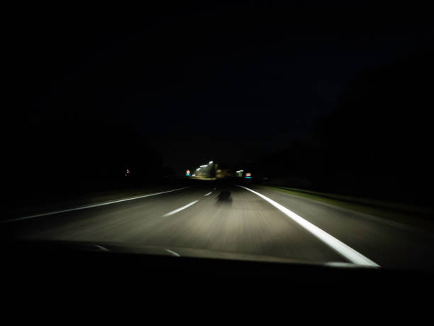 istock moving road at night shot through the windshield 1071738008