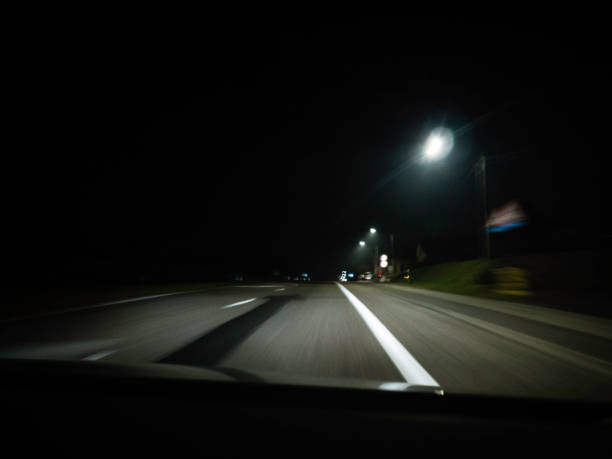 istock moving road at night shot through the windshield 1071738022
