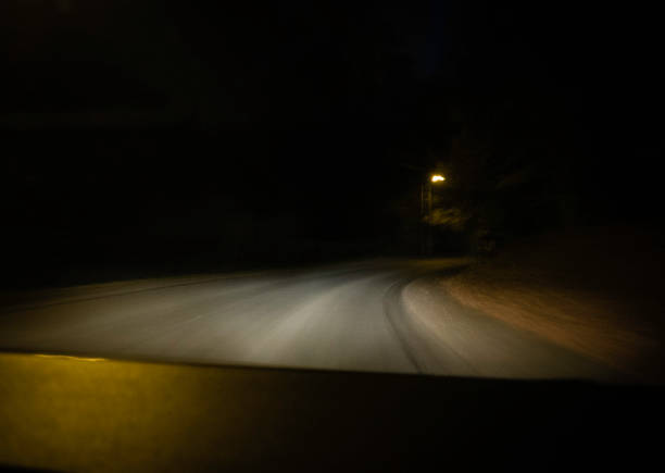 istock moving road at night shot through the windshield 1071738070