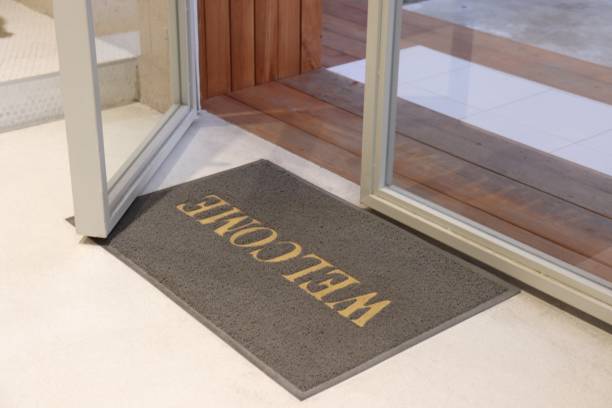istock Welcome text on grey carpet front of entrance 1071740174