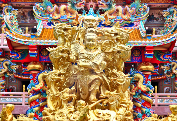 Statue of God with gold color. Located in front of the Naja Shrine in Chonburi, Thailand.