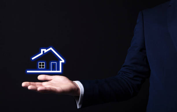 istock house icon in businessman hand 1071746230