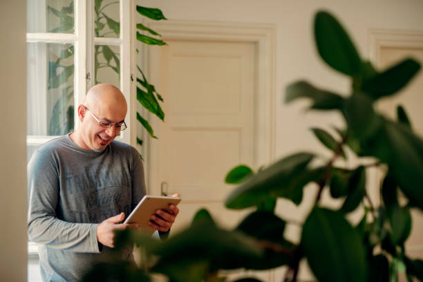 istock Senior male using a tablet for browsing the internet, happy and smiling 1071746614