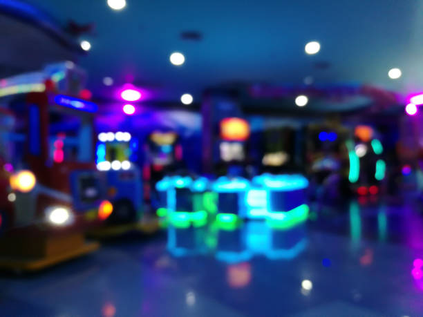 blurred arcade machine game for children game play  in department store. playground with colorful neon lights and bokeh light. colorful absract background. - department store shopping mall store inside of imagens e fotografias de stock