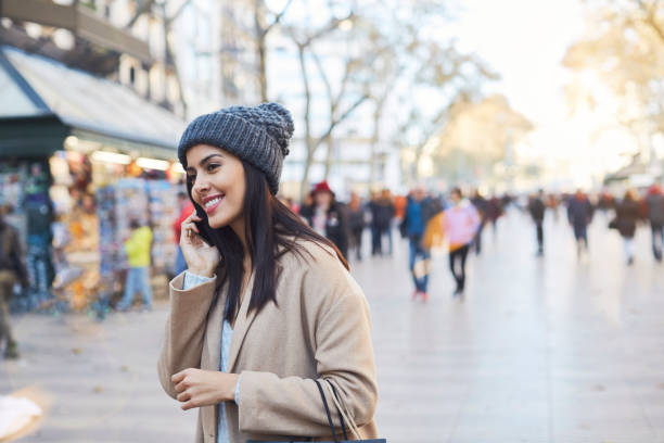 Woman talking on the phone in Barcelona's Las Ramblas Christmas shopping. Shot in Barcelona with Latin American and Polish models la rambla stock pictures, royalty-free photos & images
