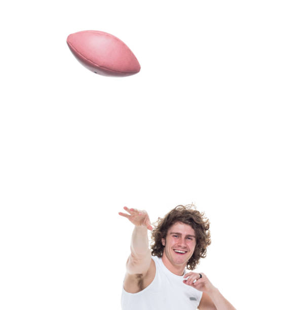 istock Man holding football 1071758286