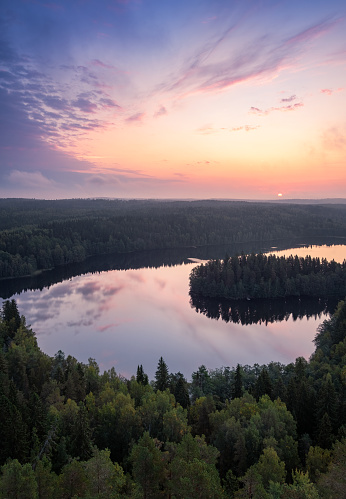 Scenic high angle landscape with sunrise, forest and lake at autumn morning in nature reserve, Finland