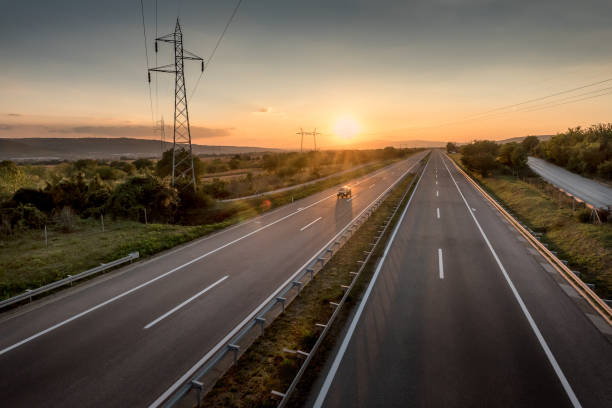 istock Single Car at a Beautiful Motorway at sunset 1071760086