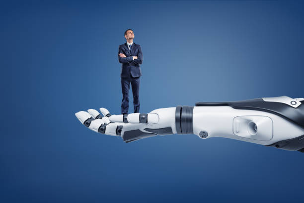 istock A small thinking businessman looks up while standing on a huge robotic arm. 1071760110