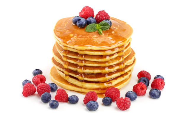 istock Pancakes stack with different berries and honey isolated on white background 1071762326
