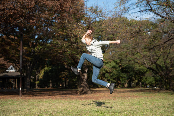istock Young man jumping in park 1071765038