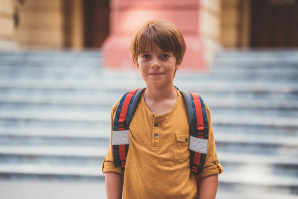 Confident schoolboy at his first day in school Portrait of cute schoolboy looking at camera boys stock pictures, royalty-free photos & images