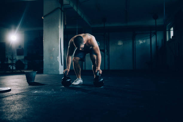 istock Bodybuilder exercising with kettlebells in the gym 1071770688