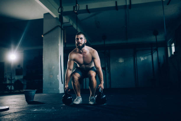 istock Man exercising with kettlebells in the gym 1071770974