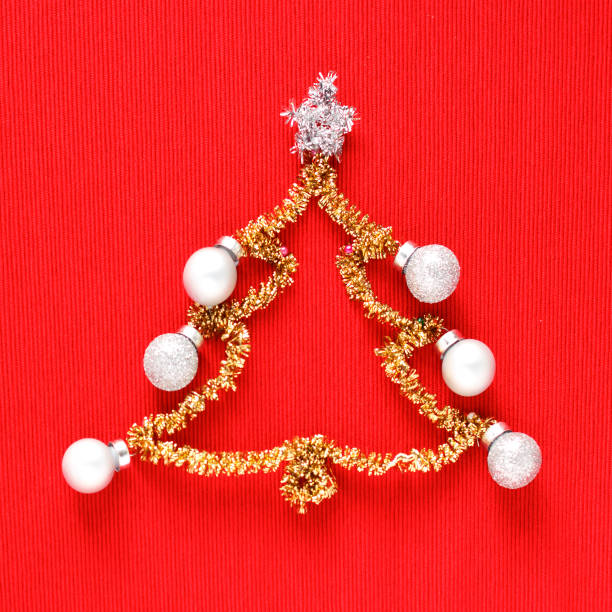 istock Gold christmas tree with colored balls on red background 1071771696