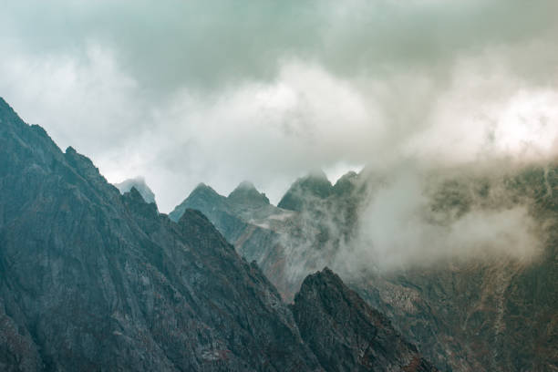 istock Beautiful mountain range covered with fog 1071772992