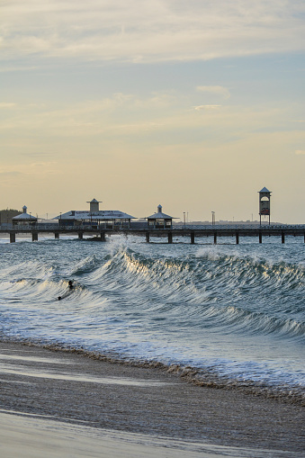 Fortaleza, Brazil - Circa November 2018: Sunset at Ponte Metalica, a wood breakwater walkway at beach in Fortaleza, Ceara, Brazil