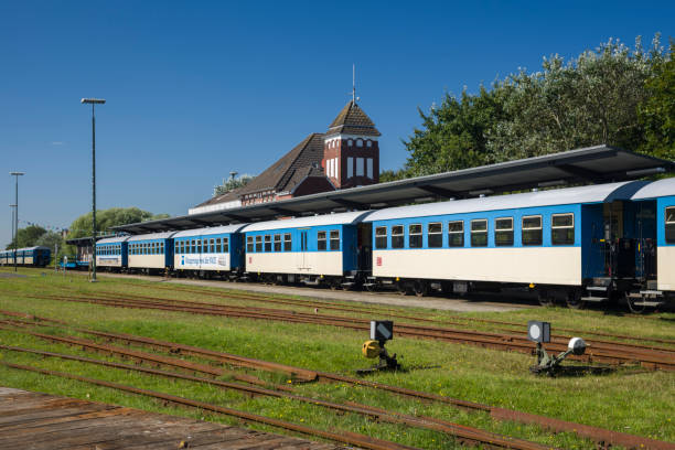 Wangerooge, Germany - September 12, 2016: Railroad cars at railroad station under clear blue sky on a splendid autumn day. No people.