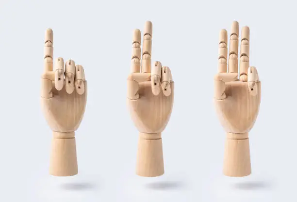 Photo of wooden raise hand with number 1, 2 and 3 posture