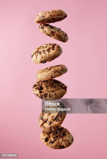 Chocolate Chip Cookies Falling In Stack Stock Photo - Download Image Now - Cookie, Flying, Falling