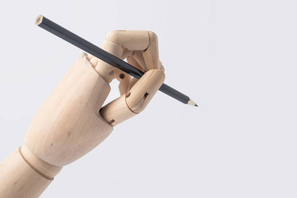 istock wooden hand hold pen isolated on white background 1071782386
