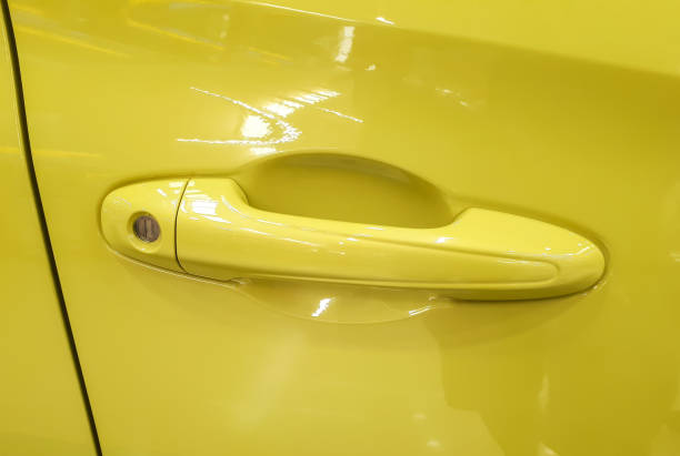 istock Car door knob in yellow color 1071783496