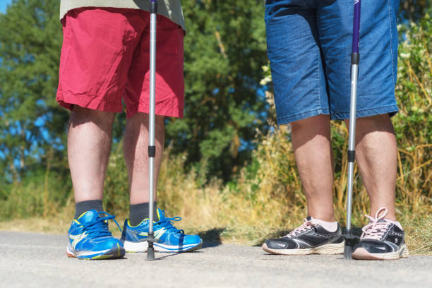 istock senior hiker's legs and hiking sticks close up 1071783586