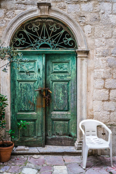 istock Old door and plastic chair 1071788568