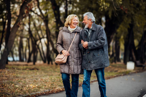 istock Smiling couple walking in a park 1071795446