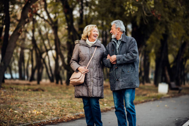 istock Senior couple walking in a park 1071795472