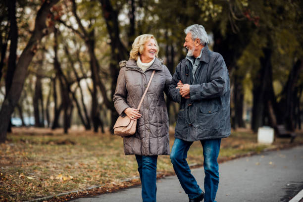 istock Happy couple walking in a park 1071795500