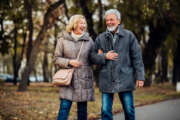 istock Smiling old couple walking at the park 1071795546