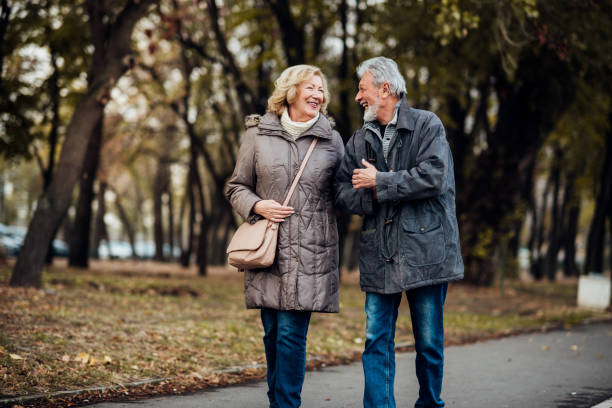 istock Married couple walking in a park 1071795564