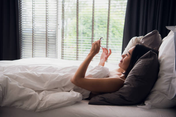 istock Beautiful young woman reading text message on her mobile phone and smiling 1071806492