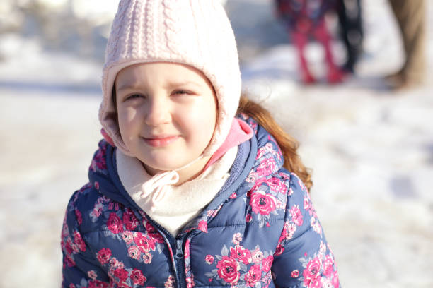 istock Girl is standing under the falling snow 1071808346