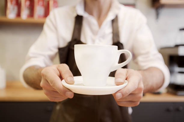 istock Barista serving cup of coffee 1071808834