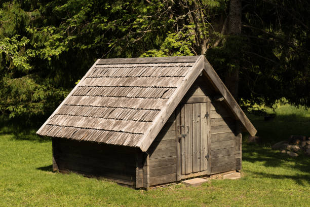 istock A wooden barn surrounded by mixed forest. Old cottage on green environment background. 1071814792